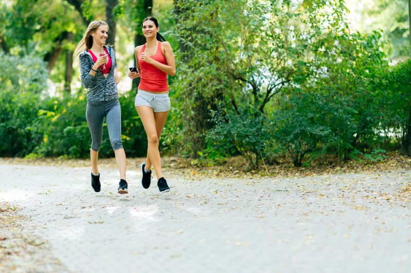 Two beautiful women running outdoors